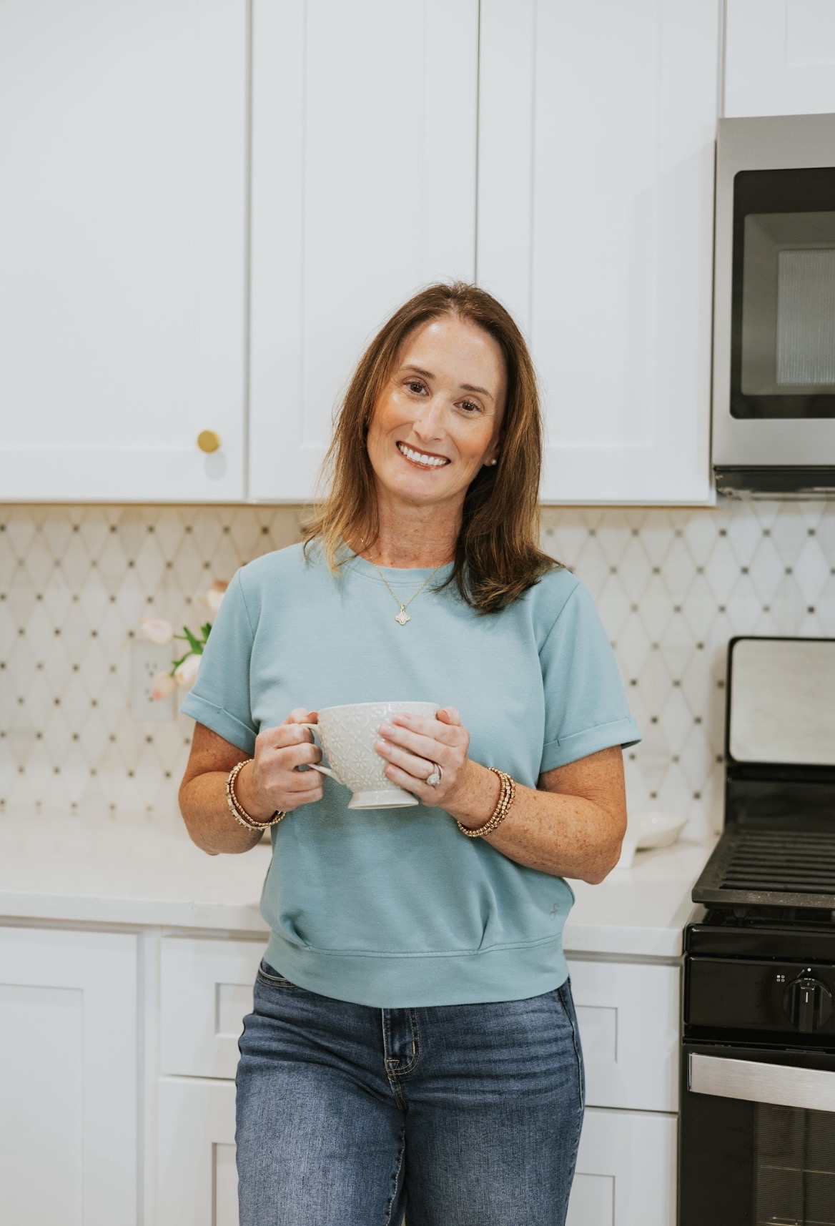 Amanda Mavrakos, M.S., CCC-SLP, smiling in a bright kitchen